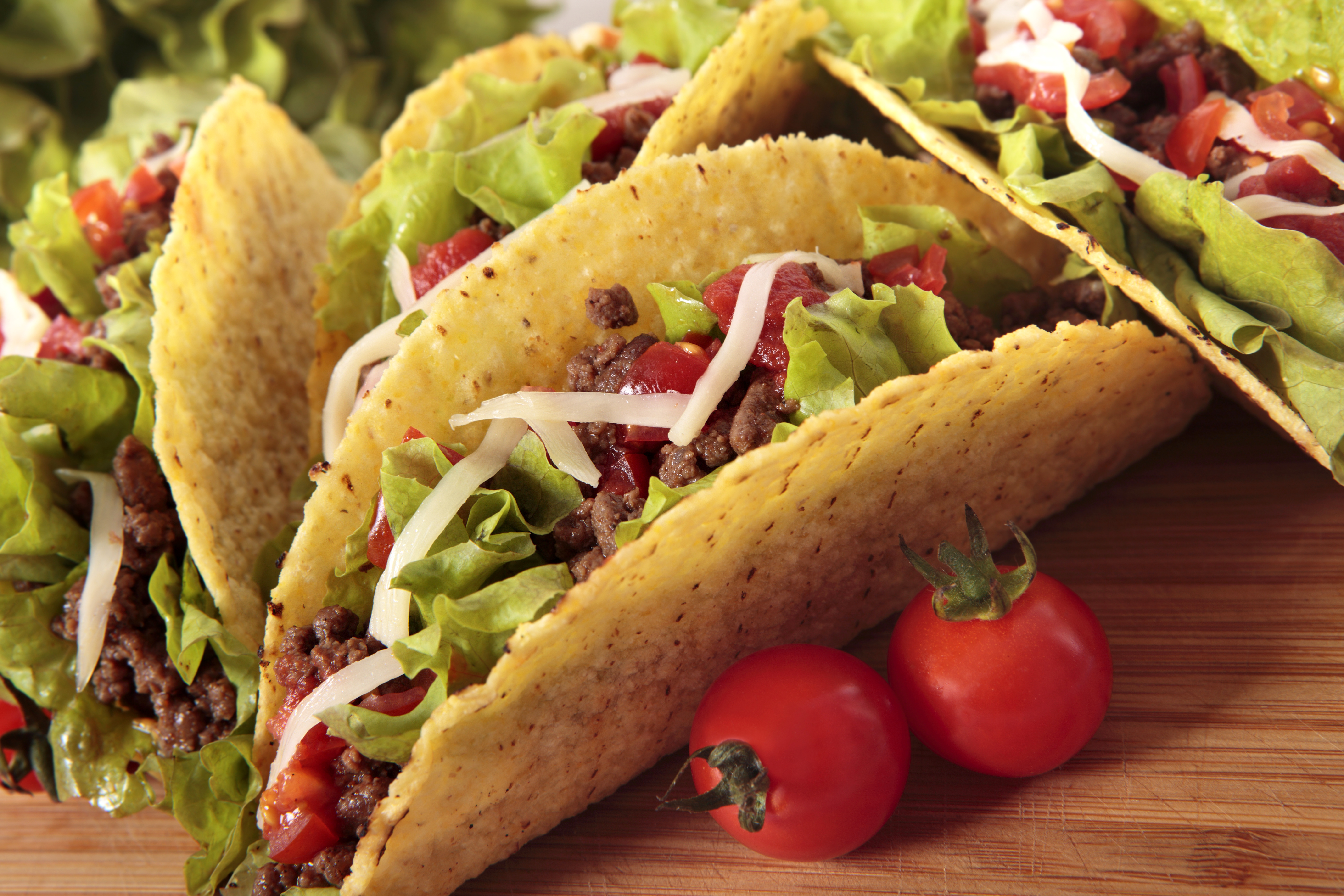 Freshly prepared tacos on a wooden table